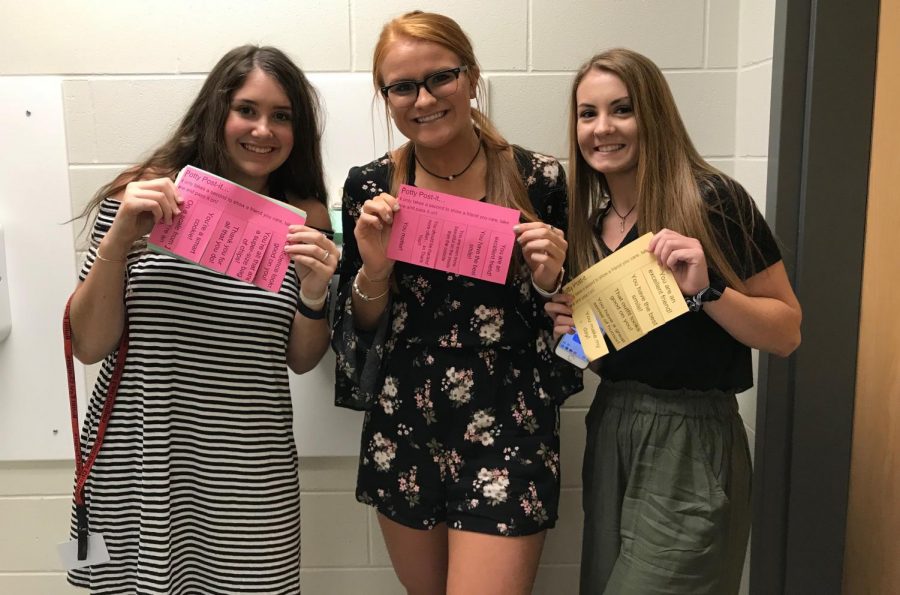 SLAM members sophomore Maggie Green, Addison Pruitt and Morgan Zirnheld spread positive notes around the bathrooms to initiate random acts of kindness. 