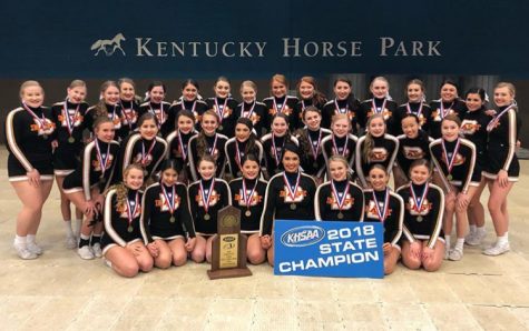 The cheerleading team is posing with the state championship trophy. They have won the KHSAA cheerleading state championship title the past five years. I was so excited and so happy when we won state this year, especially since its my final year, said Dani Williams.