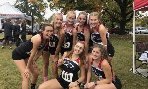 The girls on the cross country team pose after their meet. This is the second to last time they will run together as a whole on the season. All of the girls advanced to state.
