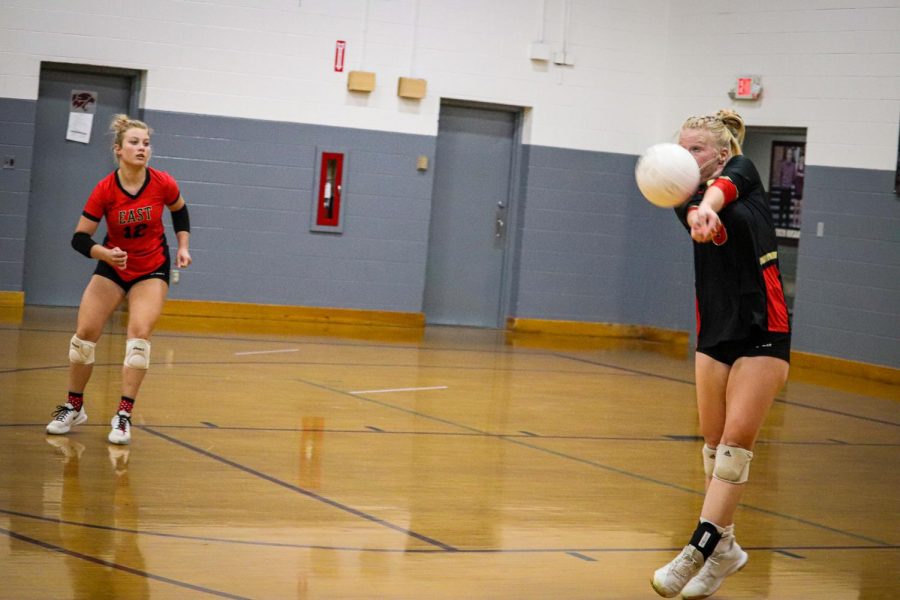 Senior Libero Mckenna Humphrey passes the ball after Holy Cross gets the ball back over the net.  