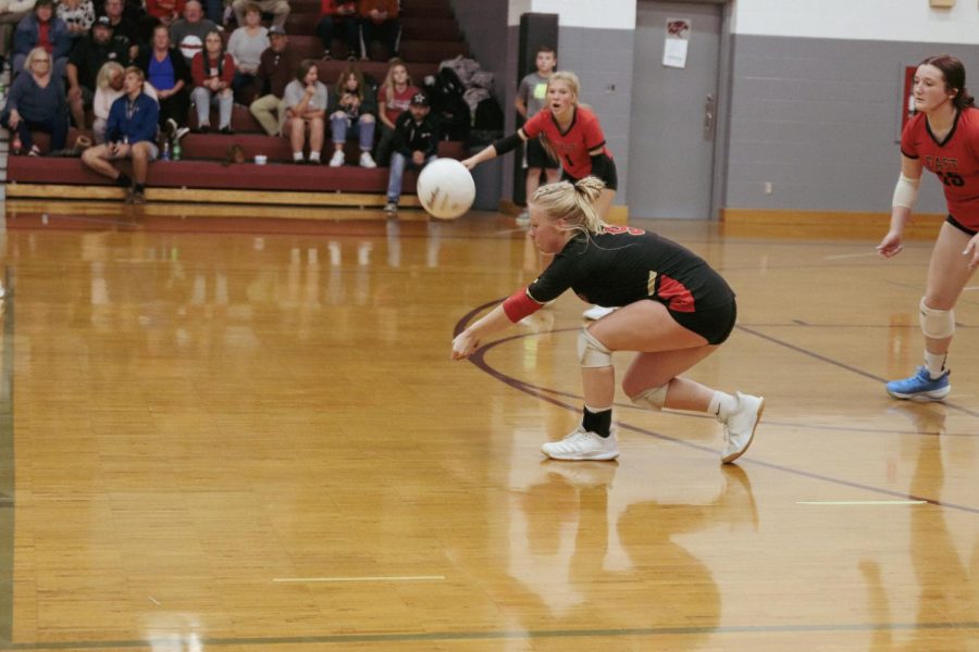 Senior McKenna Humphrey reaches for the ball after Holy Cross deep serves. We played with everything we had and put our all into the game, Humphrey said. 
