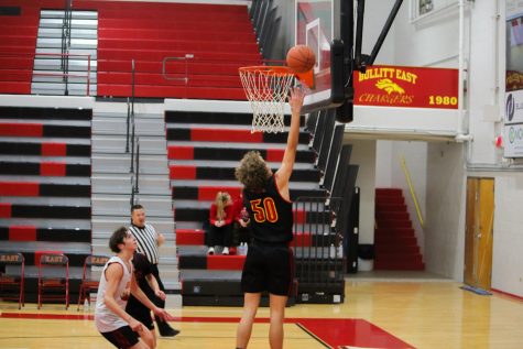 Sophomore Cooper Harkey making a layup during Charger Madness Nov. 11.
