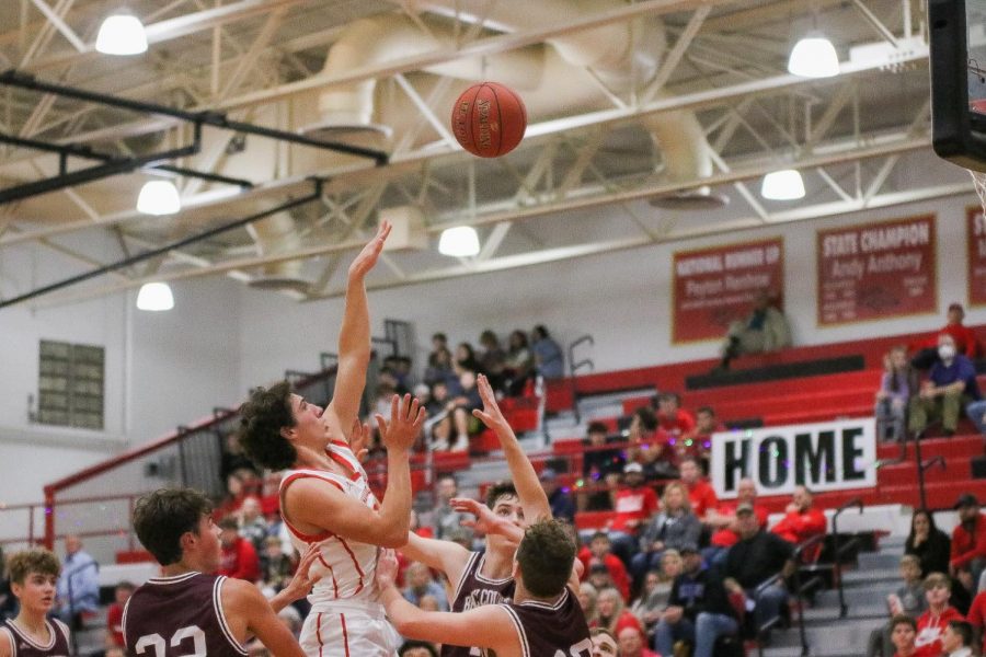 The boys played Breckinridge County Dec. 3. Junior Nolan Davenport shoots the ball over a Breckinridge County player. “We played really well and beat them by 20,” Davenport said. 