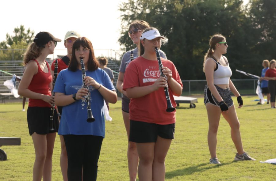 The marching band members prepare for their next competition. The band practiced throughout the week for the next performance. I think we can do a lot better than were doing right now, senior colorgaurd member Skylar Braden said. 