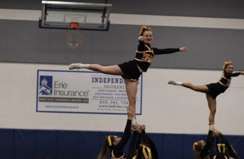 Freshman Ella Thompson flies high in a stunt. The cheer team’s new season has started. “We know that we’re good and we have the difficulty we need but I think it’s just a mindset we need to work on,” senior Carly Snellen said. Photo Credit: Kristina Neeff