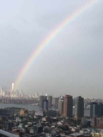 This is a picture taken by Ben Sturner this morning, September 11th 2015, of a rainbow that seems to be coming out of the site where the twin towers once stood.  