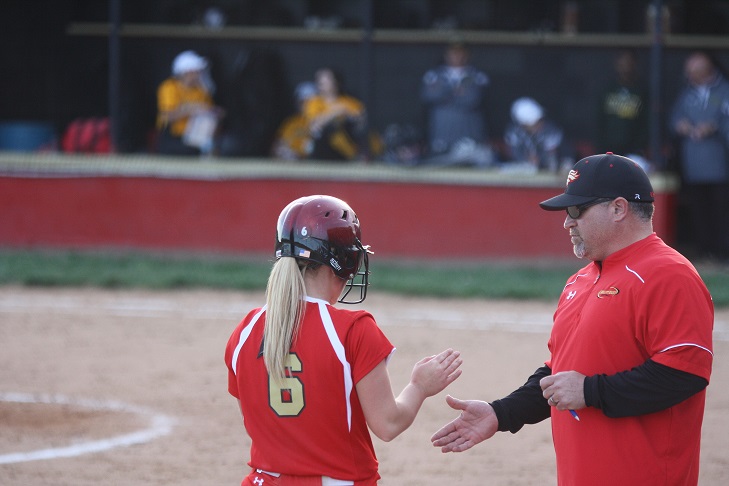 Ricky Hoffman, new volleyball coach,  with Emily Salyer during a softball game. 
