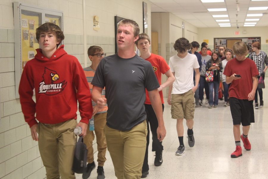 Frenchmen walking from lunch wearing shorts as that is part of the new dress expectations.
