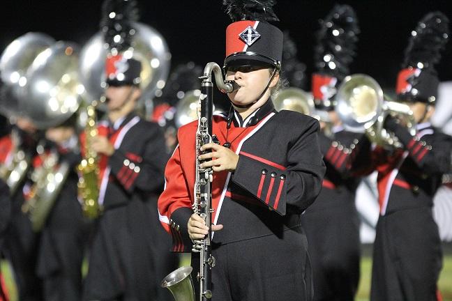 Chargers perform at a Friday night football game.