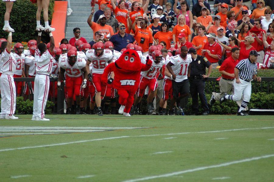 Big Red, WKUs mascot, leads the Hilltoppers out onto the field. 