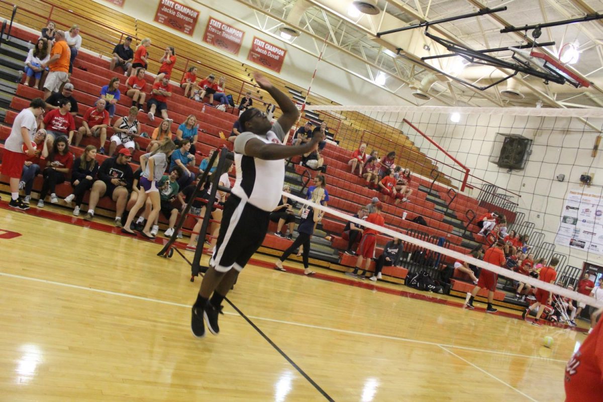 Senior Marley Michel goes up for a kill while warming up for the match.