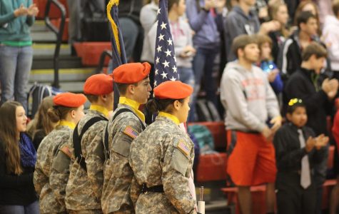 Students stand as the flag is presented