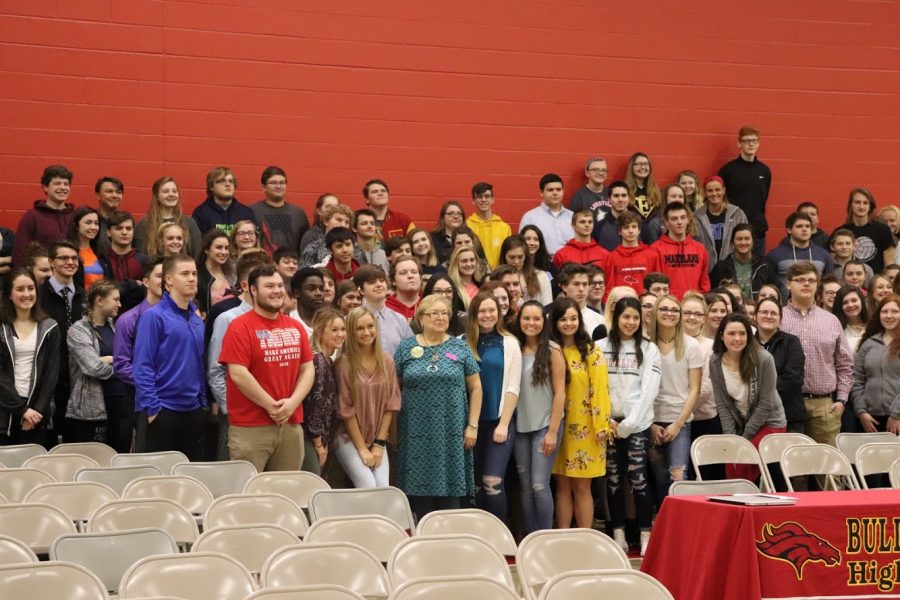 Students line up with Linda Belcher at the end of the Q and A session for a group picture.