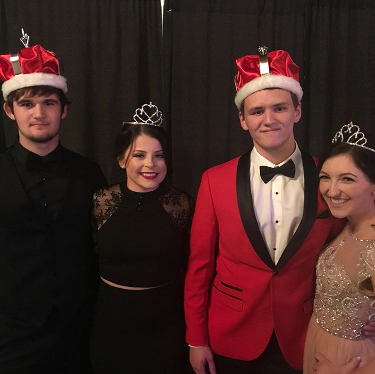 Junior and senior prom court winners pose for a picture.