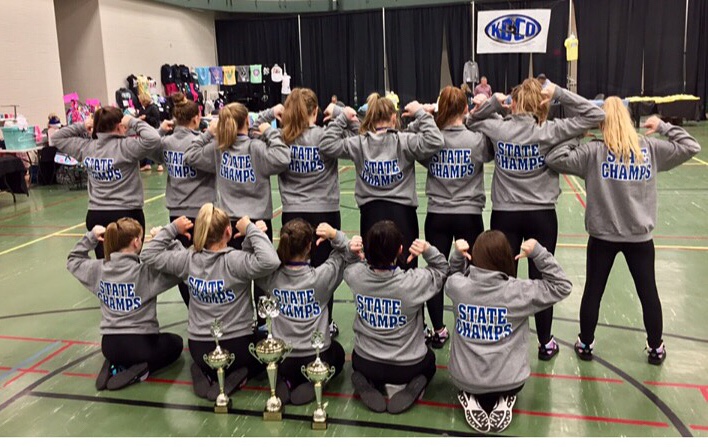 The+Bullitt+East+Dance+team+poses+with+their+winning+jackets+and+trophy.