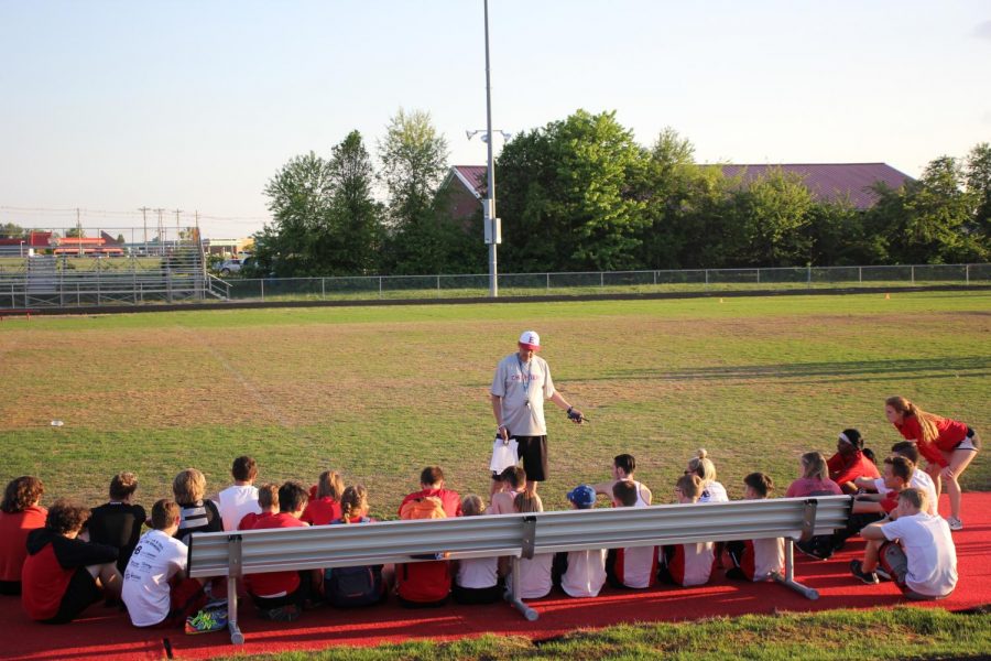 Coach Lenny Raley giving the team a pep-talk before a meet.