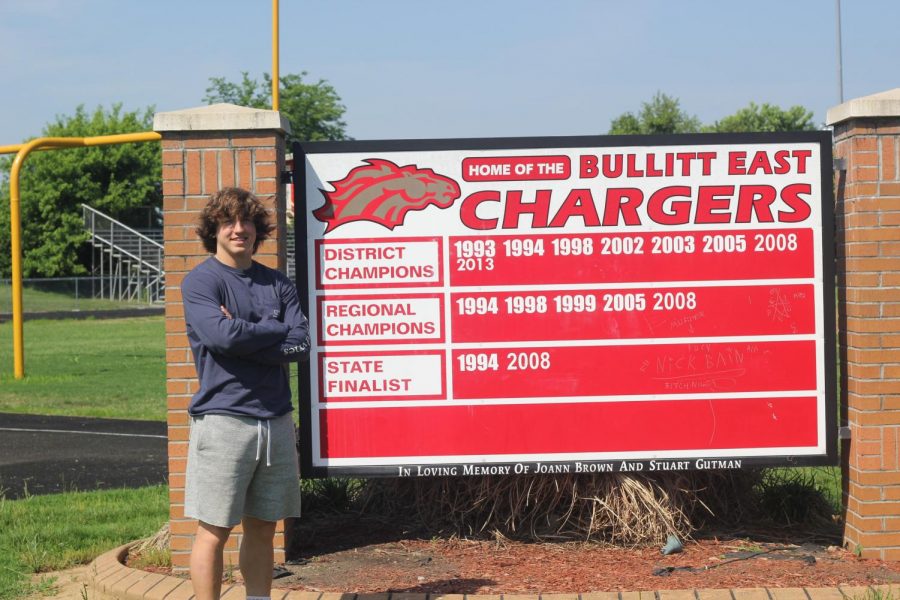 Sophomore+Max+Gauthier+posing+in+front+of+the+football+sign.