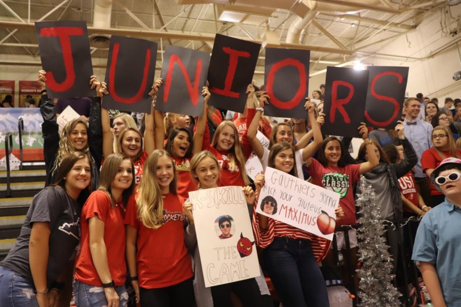 Juniors cheer on the rocketball players with several posters.