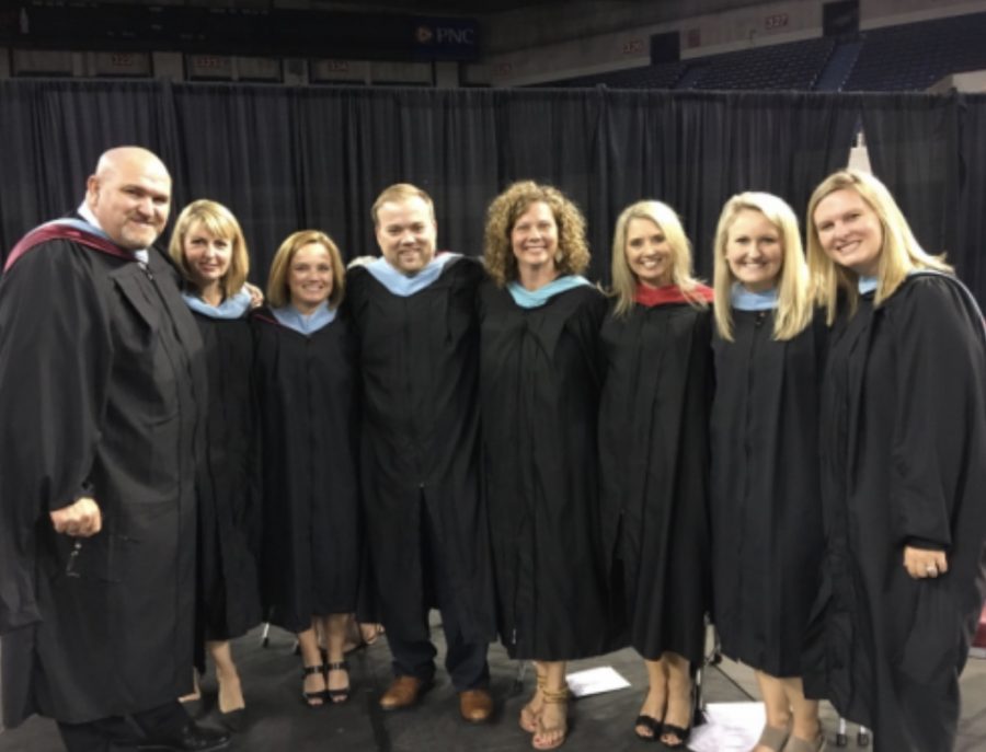 Bell with the administrators and other co-workers on graduation. Bell has developed good relationships with everyone at Bullitt East High School.
For sure going to miss all the relationships I have developed here. They are family to me, said Bell. 