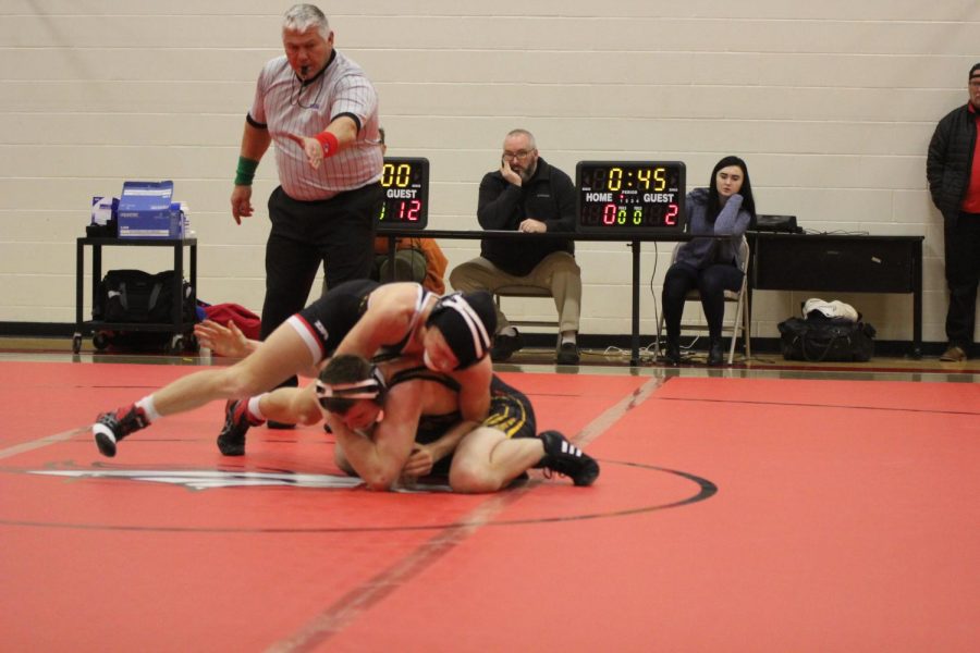 One of the members of the wrestling team competes against a wrestler from Taylor County High School at a home match on Jan. 9. Although Bullitt East did not win the competition, each member's participation further prepared them for the Regions and State tournaments in February, in which they are working towards becoming a champion in, by allowing them to realize their weaknesses and improve upon those during the remainder of the season. "After each competition, we point out what the wrestlers do well and what mistakes each wrestler has to correct and work on," said the wrestling coach, Tom Wells.