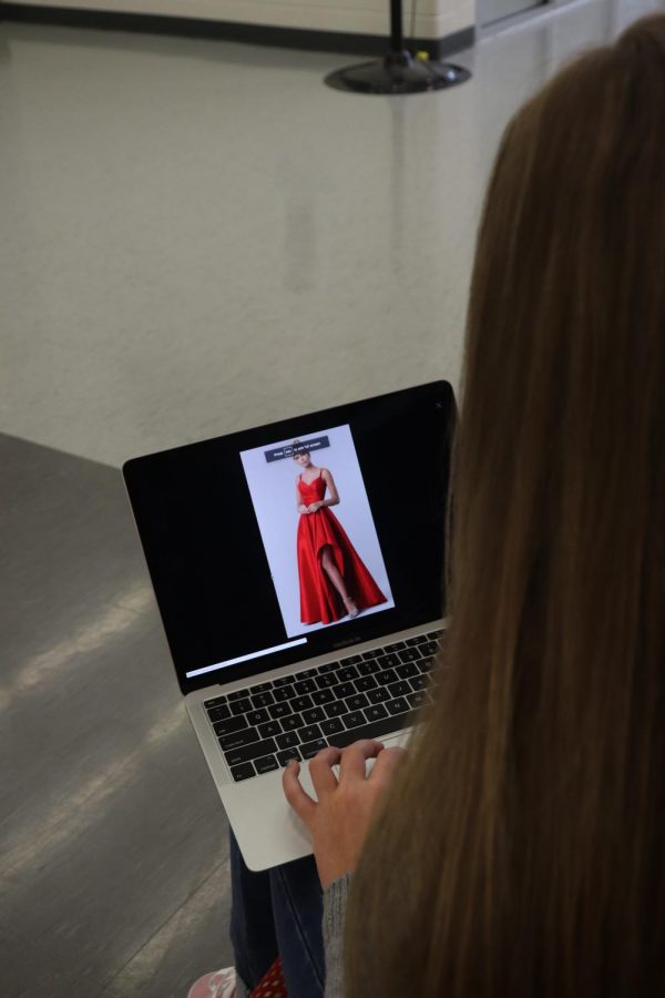 Junior Lexi Lutz, prepares for prom by looking at dresses.