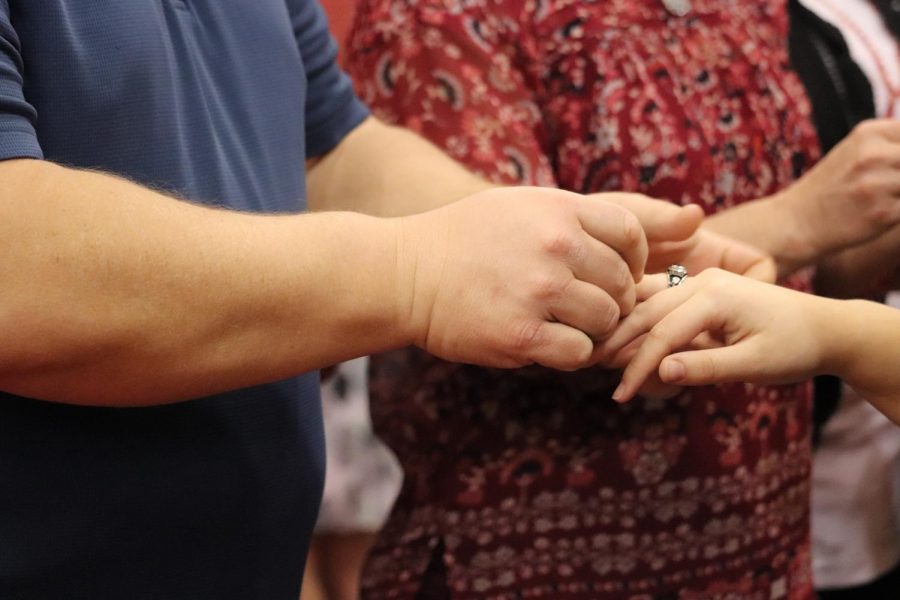 Father presents daughter's ring in the junior ring ceremony.