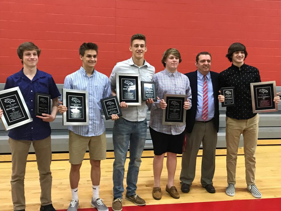 The+boys+basketball+teams+five+seniors+from+last+season%2C+holding+their+awards++with+head+coach%2C+Jason+Couch