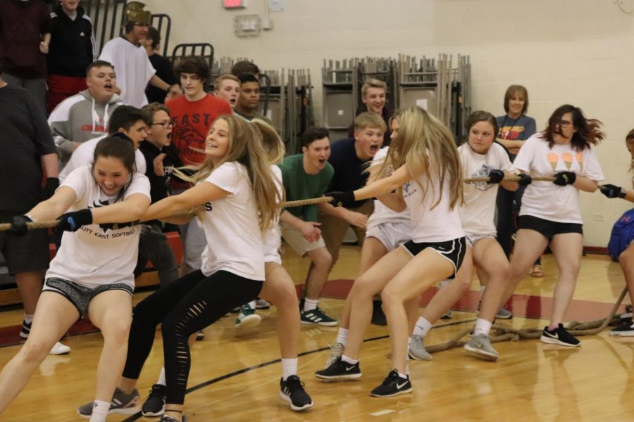 Members of one of the sophomore girls teams for tug-of-war express their determination to win this competition while students cheer them on from the side during the annual Greek Games on May 2. The tug-of-war competitions comprised much of the time devoted to activities that the Games featured, in which students utilized their aggressiveness to try to assert their dominance over other grade levels, while many students inversely chose not to participate to avoid being subordinated for the same reasons. "Freshmen are new and want to save face. Sophomores and juniors are jaded and want to keep their image. They tend to hold themselves in high regard and don't want to embarrass themselves," said band teacher Trevor Ervin.