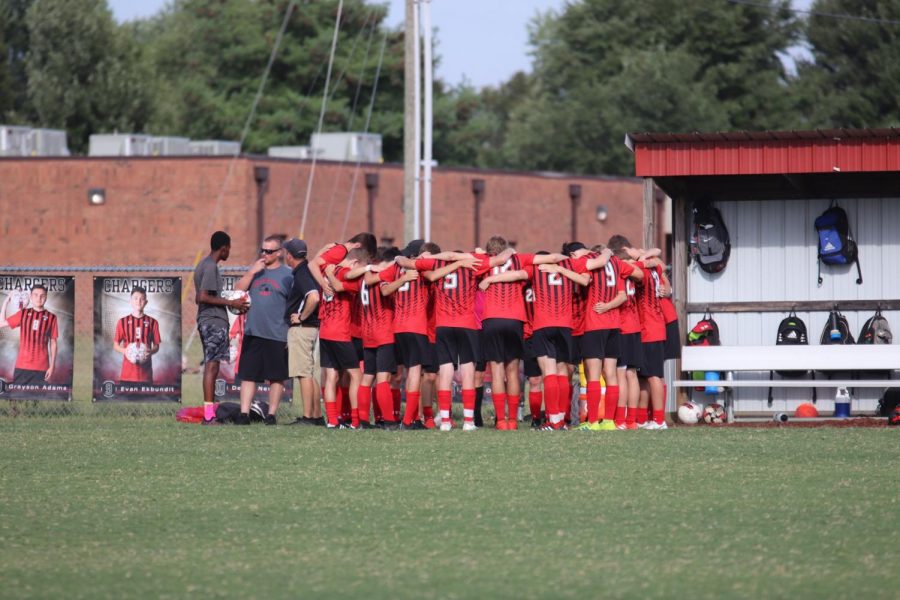 The boys soccer team huddle together before the game against Fort Knox.