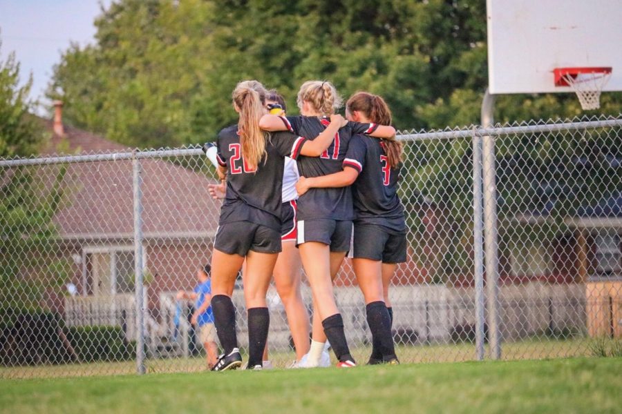 Seniors Rylee Ortaga and Emily Ezell help junior Bailey Chitwood off the field after being tackled by Male goalie.