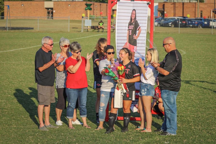 Surrounded by family while her favorite memory and advice to younger teammates was being read off, senior Brookelynne Montague stood surrounded by family during the senior night ceremony. All of the seniors were lined up as they were recognized one by one. “It felt so unreal to be standing there in front of my teammates, classmates, family, and friends as we were being called one by one to be recognized. I guess you could say it truly was a bittersweet night,” said Montague.