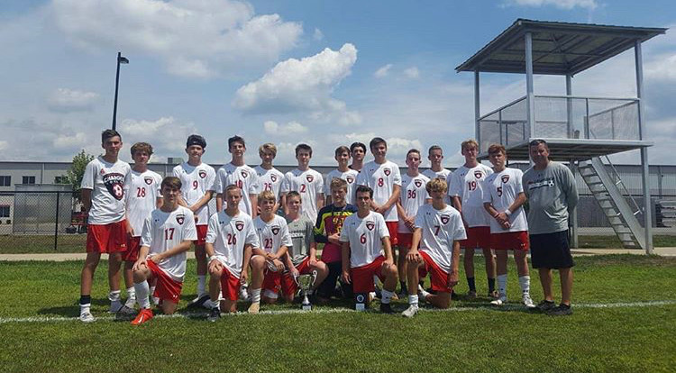 Chargers pose with their trophy, celebrating the win in the Mulhenbueg Tournament 