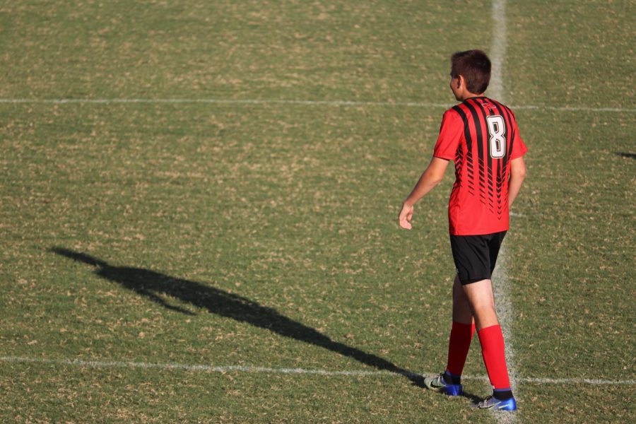 Senior, Grayson Adams, looks out at the field to watch where the ball is going next. 