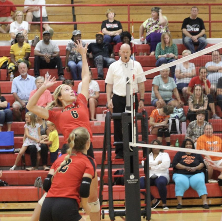 Senior Carissa Kimball goes up to spike the ball. The team won this game against the Fern Creek Tigers 3-0.