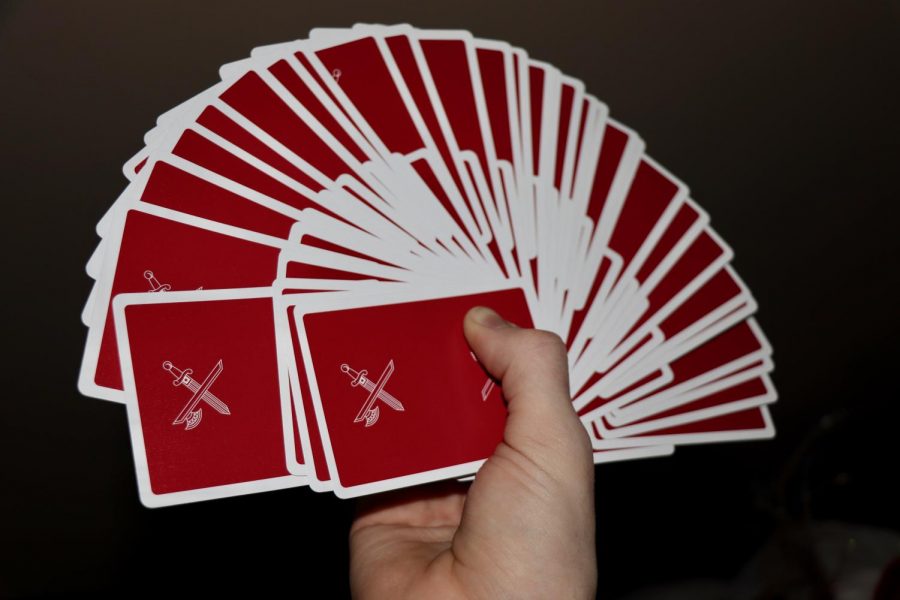 Sophomore Brodie Curtsinger doing a cardistry move called a “giant fan” with the Blood Red Kings Version Two deck of cards by card creator and magician Daniel Madison.