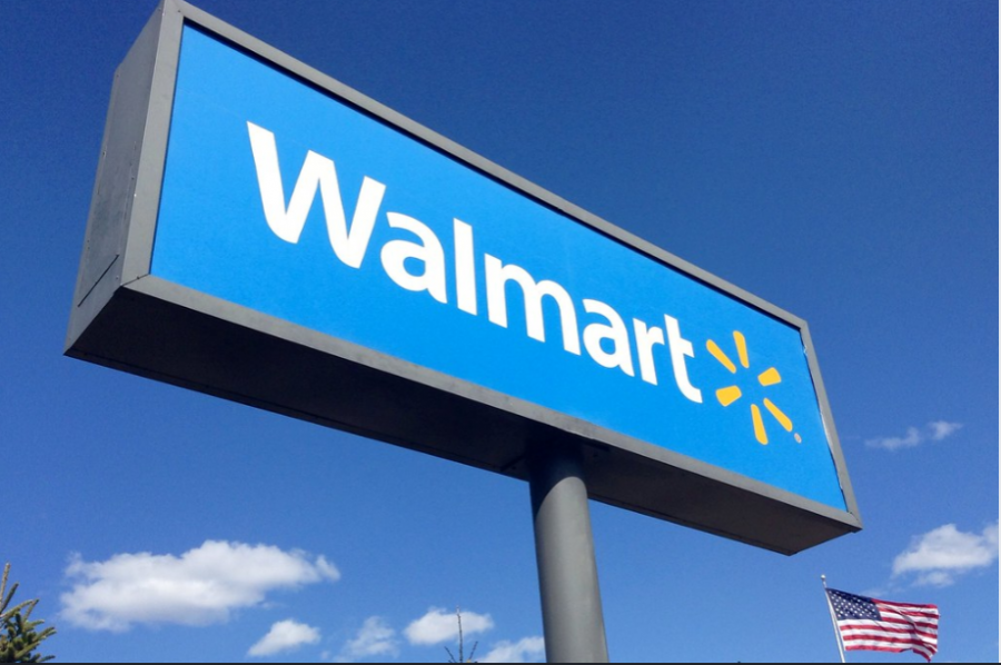 The Walmart sign in front of the American flag.