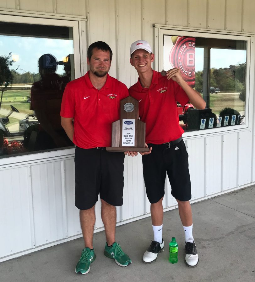 Coach Kyle Downs and senior Aiden Robison holding trophy of second place from regionals. The boys golf team placed second at regionals on Oct. 1, against 12 other teams, and Robison and junior Thomas Bryan earned a spot in the state tournament. “Thomas and I are going to get prepared for state by playing a ton. We want to show the state that Bullitt East has some great golfers,” said Robison. 
