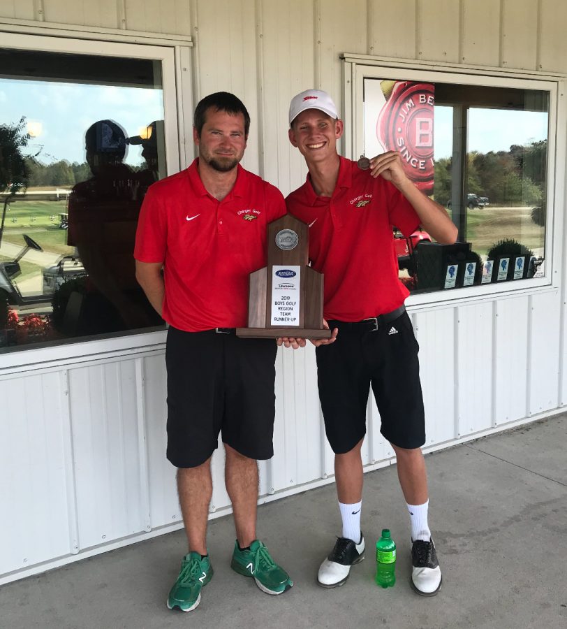 Coach+Kyle+Downs+and+senior+Aiden+Robison+holding+trophy+of+second+place+from+regionals.+The+boys+golf+team+placed+second+at+regionals+on+Oct.+1%2C+against+12+other+teams%2C+and+Robison+and+junior+Thomas+Bryan+earned+a+spot+in+the+state+tournament.+%E2%80%9CThomas+and+I+are+going+to+get+prepared+for+state+by+playing+a+ton.+We+want+to+show+the+state+that+Bullitt+East+has+some+great+golfers%2C%E2%80%9D+said+Robison.+