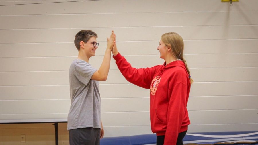 Haylie Lewis interacting with Cameron White during their adaptive PE class.