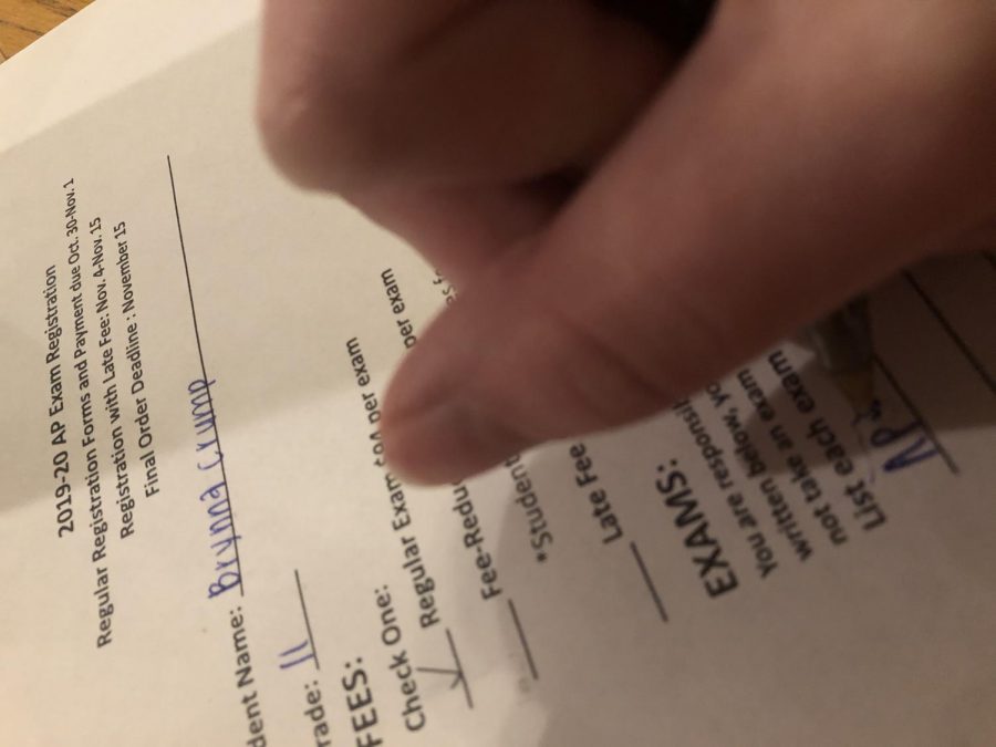 Filling out a registration paper, Brynna Crump signs up for her AP exams. AP exam registration took place between Oct. 30, 2019 till Nov. 1, 2019 . Im taking two AP exams this year, AP lang and AP US history. Ive got a five and a three in the past so Im hoping for both fours this year, said Crump, junior.