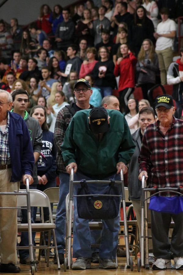 Three elder veterans from the assembly stand to be recognized for their branch of military. Veterans ranging in all ages were recognized during the ceremony. Marillia said, Realizing that during the Vietnam War, the guys who were in the trenches were not coming back home. That was hard.