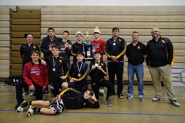 The wrestling team poses with their trophy. The team had seven top four placers in their tournament. They look to build onto this success as the season goes on.