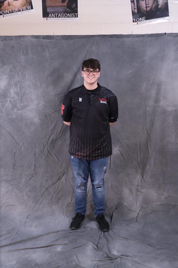 Junior Adam Young posing in front of a screen for a photo. Young is the fourth best bowler on the bowling team, with an average of 181. “I feel like it’s going to progress really well. We’re doing pretty good right now, staying consistent. I hope that we can make it to at least regionals, and win; go to state overall,” said Young.