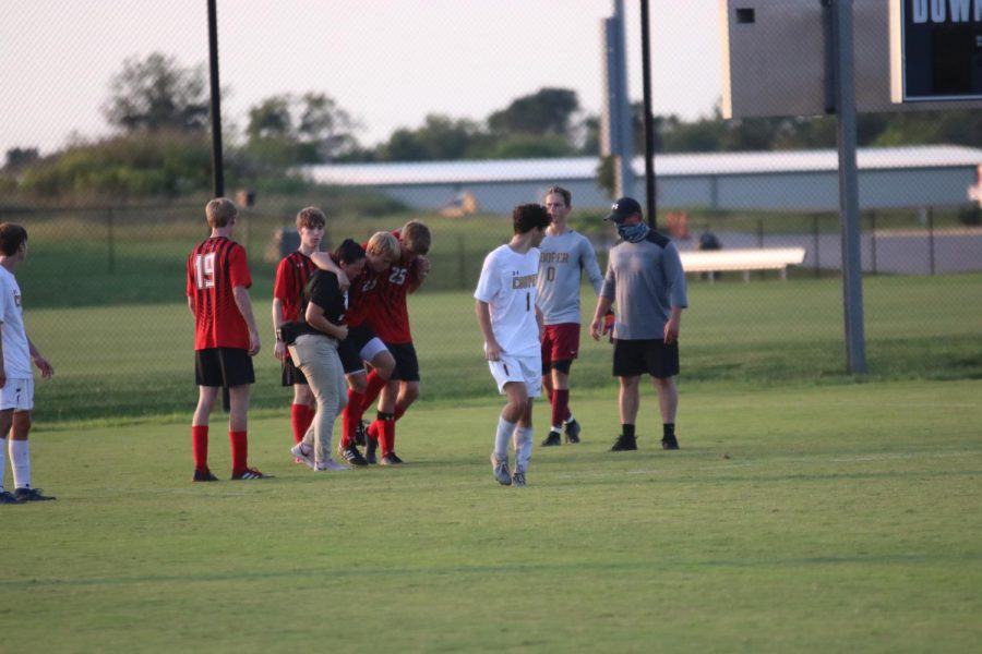 Sophomore Colin Elder gets carried off the field after season ending injury.