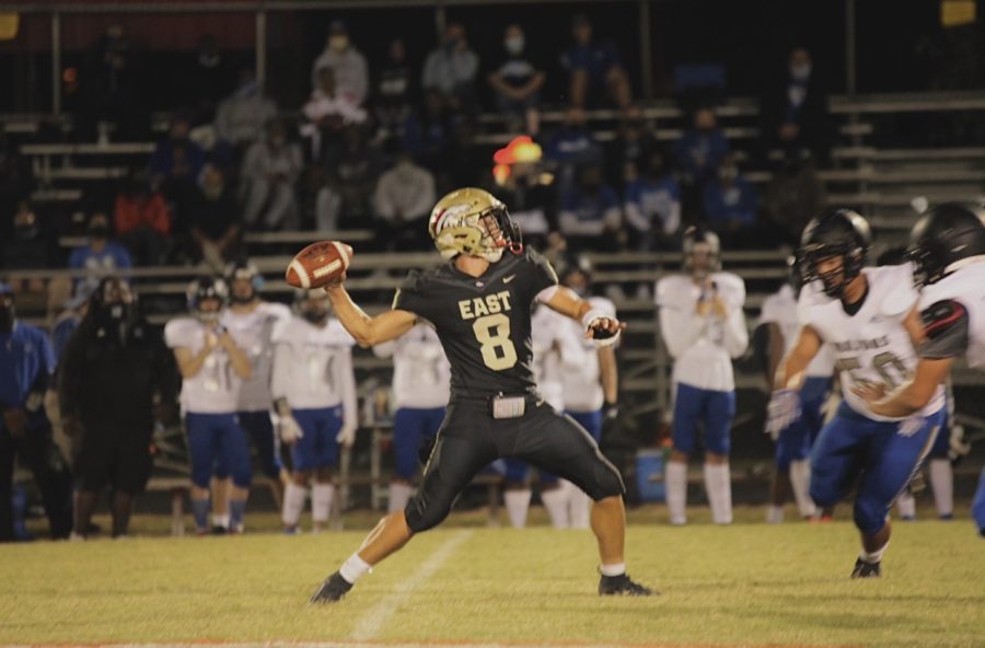 Senior quarterback Aeron Adams throwing the football, as the other team tries to tackle. Adams was one of the main key players, for this season of football. “The atmosphere, and playing football, are going to be what I miss most about high school football,” said Adams.