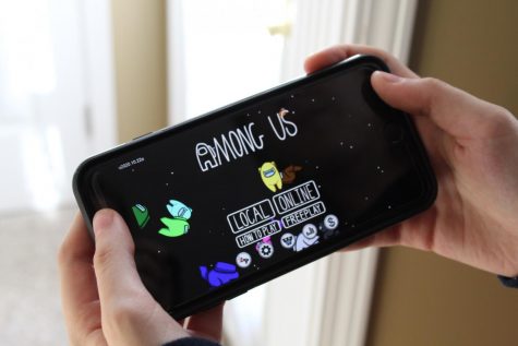 The among us homescreen, featuring the outer space setting and the characters from the game.