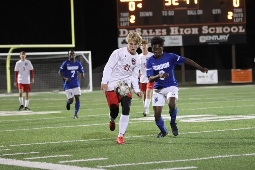 Sophomore Colin Elder fights for the ball against Iroquois High School. He has played both seasons of his high school career on the team and has made an immediate impact on and off the pitch.  