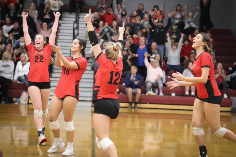 The team celebrates as they score a point in the close game against Holy Cross in the first round of regionals. Our season definitely was one of the best Ive had. We were a very talented team who loved the game, senior Morgan Butler said. 