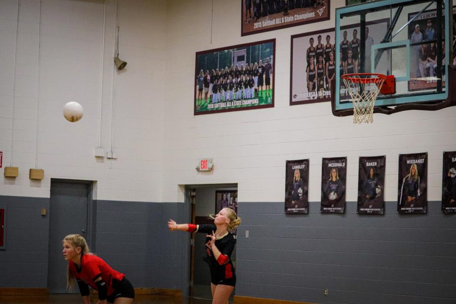 Senior libero McKenna Humphrey serves the ball in the first round of regionals against Holy Cross. "Volleyball has been my life for 11 years and I'm going to miss being with the  same girls I have been with five years," Humphrey said.