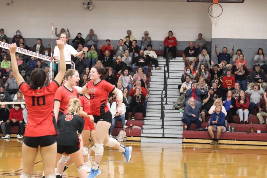 The team celebrates after a rally in the game. The Lady Chargers took on Holy Cross Oct. 25 in the first round of regionals and lost 3-1. Getting a good point in the game after a long rally really sets the mood of the game. My teammates are my  family and getting to play with them was the best part about the sport, senior Grace Satterfield said. 